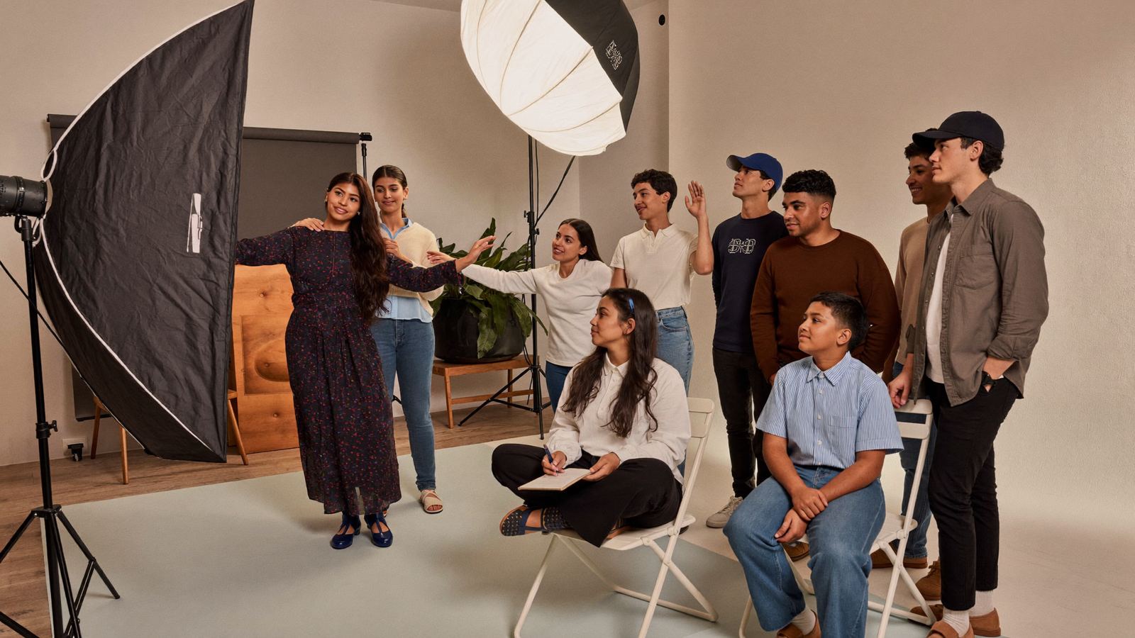 An Auraa instructor leading a class of new models in a photo studio
