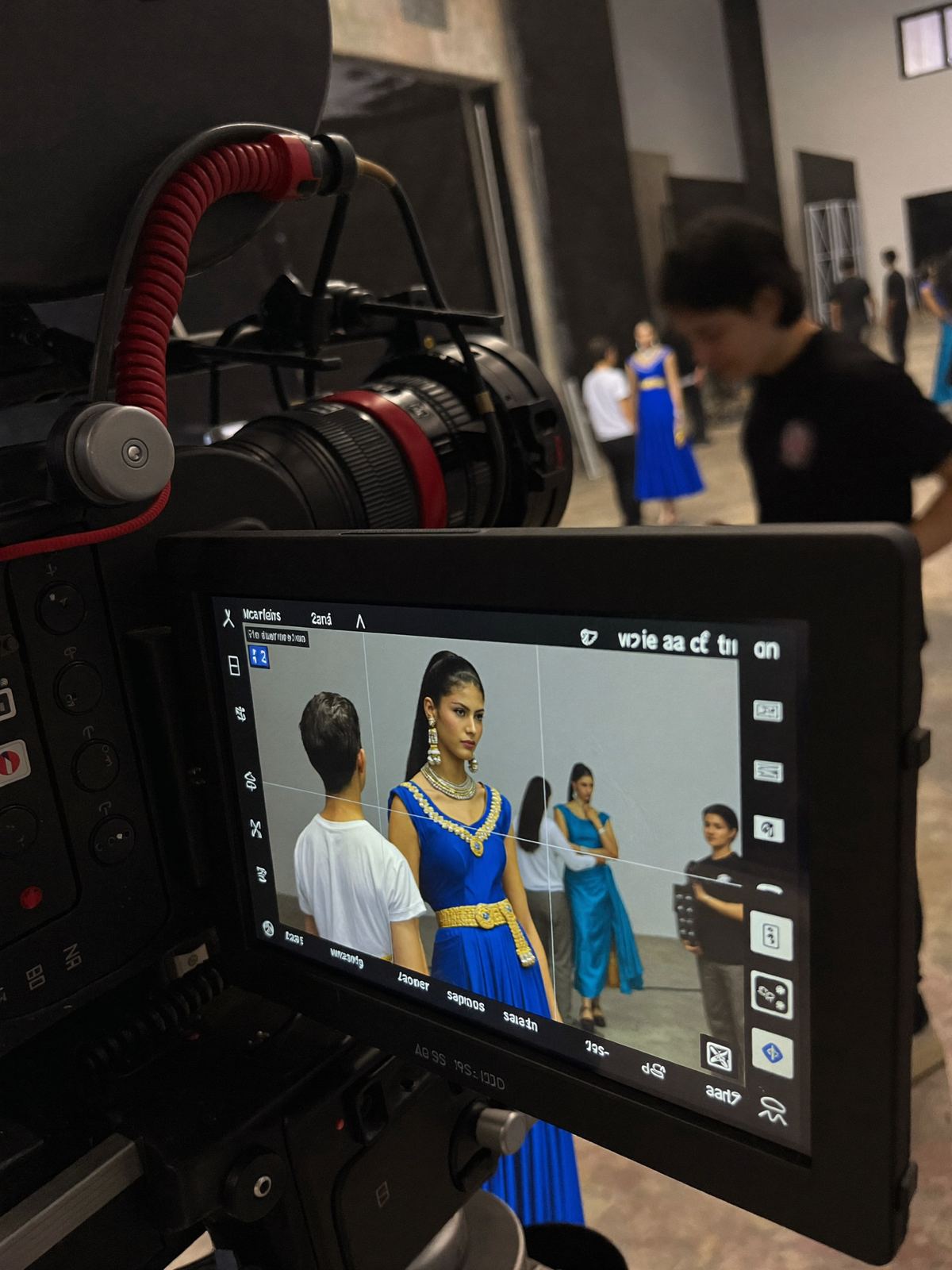A cinema camera filming a model on set